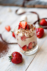 Sweet white dessert of tiramisu with fresh red berries of strawberry