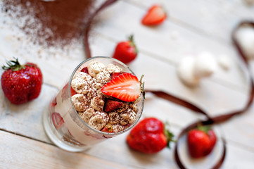 Sweet white dessert of tiramisu with fresh red berries of strawberry