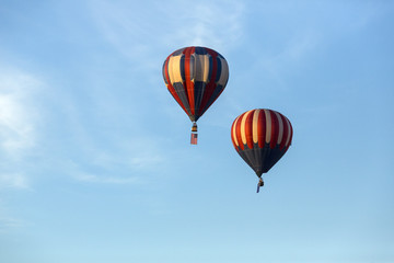 American flag and Nevada state flag flying with hot air balloons