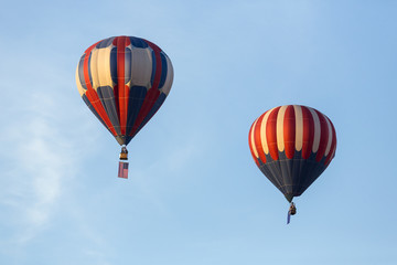 American flag and Nevada state flag flying with hot air balloons
