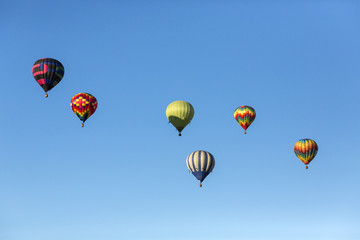Hot air balloons flying in a beautiful blue clear sky