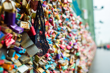 Fototapeta na wymiar Bridge View Cologne where people express their love padlocks hanging on the fences of protection. Women's panties hang on locks