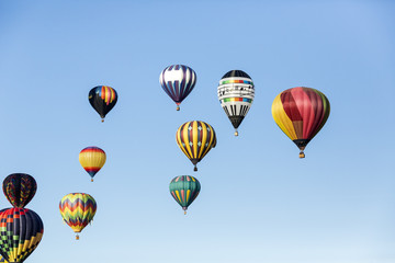 Hot air balloons flying in a beautiful blue clear sky