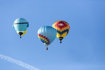 Hot air balloons flying in a beautiful blue clear sky