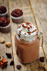 Hot dark chocolate with whipped cream and chocolate cakes