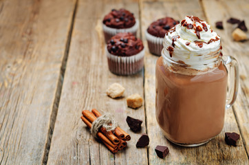 Hot dark chocolate with whipped cream and chocolate cakes