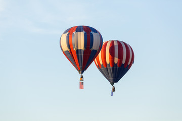 Fototapeta na wymiar American flag and Nevada state flag flying with hot air balloons