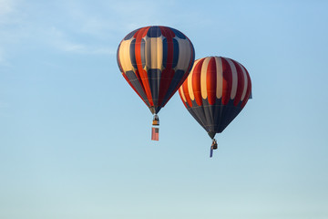 American flag and Nevada state flag flying with hot air balloons