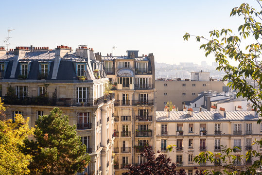 Paris, France. View on French Parisian apartments  and  flats with typcial balconies. Cityscape panorama from park in front of Sacre Coeur in Paris, France.