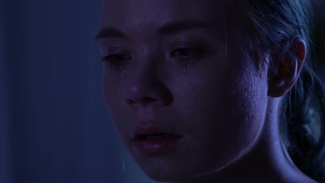 Unhappy young woman crying, psychological trauma, domestic violence, closeup