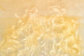 golden paint in water abstract background with waves. shiny particles spread out