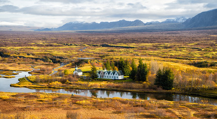 plain thingvellir national park in reykjavik enters to the iceland golden circle. countryside with river, church, houses on mountain landscape in Iceland. best vacations. perfect morning. - obrazy, fototapety, plakaty