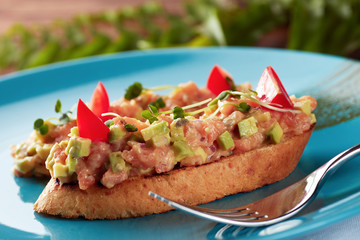 Salmon and avocado tartare with toast