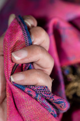 Blurred cashmere fabric hold in a woman's hand