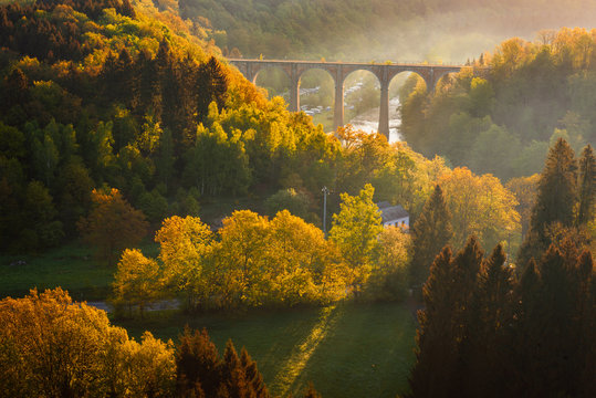 Ardennes, Belgium. Sunrise in countryside and forest near Herbeumont with wonderful viaduc of Hebeumont Viaduc of Conques across Semois river. Luxembourg province, Ardennes region, Wallonia, Belgium.