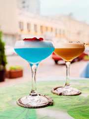 Colorful cocktails standing on the table on bar's terrace outdoor 