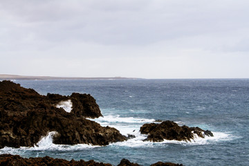 The infinity ocean licking the rocks on the coast of Lanzarote, Canary Islands