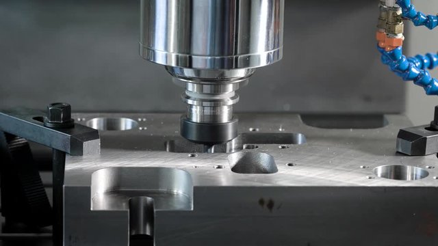 detail is fixed on a moving platform of automatic cutting machine in a shop of factory, close-up of process