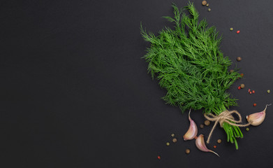 A bunch of fresh dill on a black board