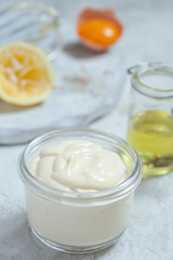 Obraz na płótnie Canvas Homemade mayonnaise sauce and olive oil, eggs, mustard, lemon