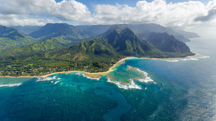 View on Tunnels Beach with the reef and Wainiha from Haena Point, aerial shot from a helicopter,...