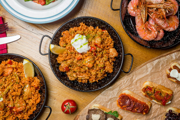 Assorted Spanish food set Paella seafood platters, grilled seafood, tapas, pranws, tomato soup, churros
