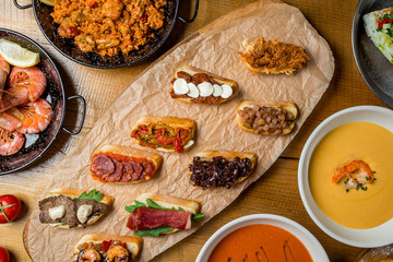 Assorted Spanish food set Paella seafood platters, grilled seafood, tapas, pranws, tomato soup, churros