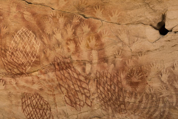 Aboriginal stencil rock art of hands, nets and stone axes at Cathedral Cave, Carnarvon Gorge,...