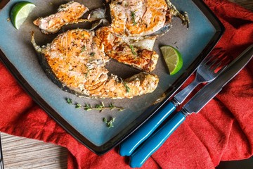 Delicious salmon steak grilled with lemon and pepper on a plate