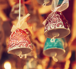 Souvenir christmas ceramic bells at the market, seasonal holiday background
