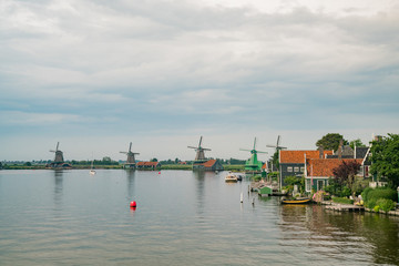 Fototapeta na wymiar De Gekroonde Poelenburg, De Kat, Windmill De Zoeker, Houtzaagmolen het Jonge Schaap windmill and river view