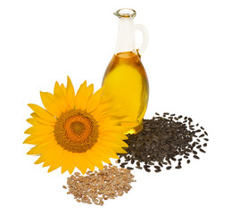 Creative idea flower of a sunflower, seeds and oil glass bottle isolated on white background. Food,...