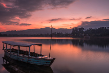 Moored boat on a lake under beautiful sunset, Bandung, Indonesia