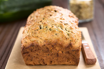 Loaf of fresh homemade zucchini and walnut quick bread (Selective Focus, Focus on the front upper edge of the bread)