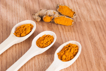 Turmeric powder in the wooden bowl (Curcuma longa)