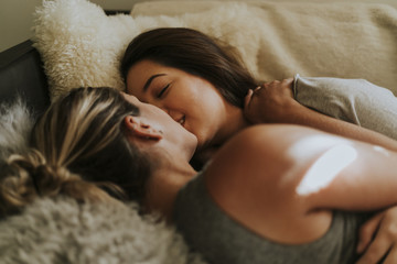 Lesbian couple together in bed
