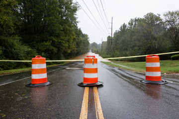 Waxhaw, North Carolina - September 16, 2018: Barricades block a roadway flooded by rain from...