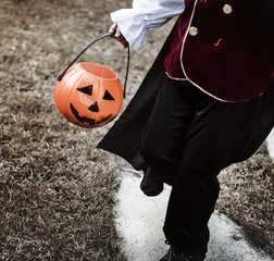 Closeup of young pirate holding Halloween bucket