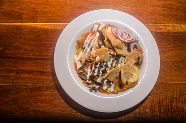 Traditional mexican chilaquiles with beef and chicharron