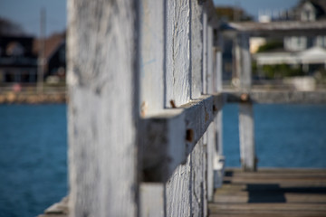 wooden white fence in need of repair on dock