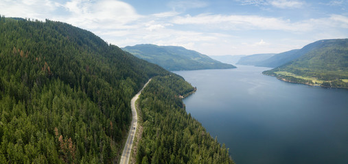 Aerial view of Trans-Canada Highway during a vibrant sunny summer day. Taken near Shuswap Lake, Sicamous, BC, Canada.