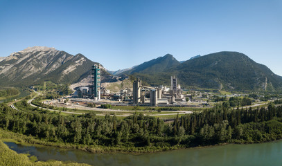 Aerial view of an industrial site in the Canadian Rockies during a vibrant sunny summer day. Taken near Calgary, Alberta, Canada.