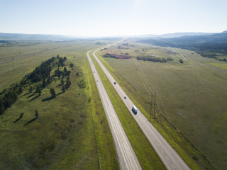 Aerial view of Trans-Canada Highway during a vibrant sunny summer day. Taken near Calgary, Alberta, Canada.
