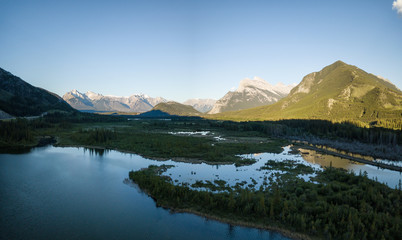 Naklejka na ściany i meble Aerial panoramic view of Vermilion Lakes during a vibrant summer sunset. Taken in Banff, Alberta, Canada.