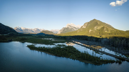 Aerial panoramic view of Vermilion Lakes during a vibrant summer sunset. Taken in Banff, Alberta, Canada.