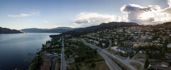 Aerial panoramic view of a small town on the hill near Okanagan Lake during a vibrant summer...