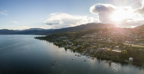 Aerial panoramic view of a small town on the hill near Okanagan Lake during a vibrant summer...