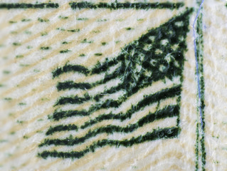 An extreme colored closeup macro detail microscopic image of printed currency showing the layering of applied materials, threads, and strands of the flag on top of the white house.