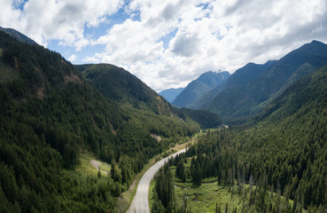Aerial panoramic view of a scenic road going through the valley surrounded by the Beautiful Canadian Mountains. Located between Hope and Princeton, BC, Canada.