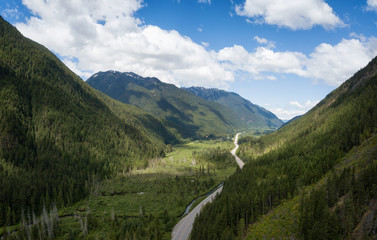 Aerial panoramic view of a scenic road going through the valley surrounded by the Beautiful Canadian Mountains. Located between Hope and Princeton, BC, Canada.